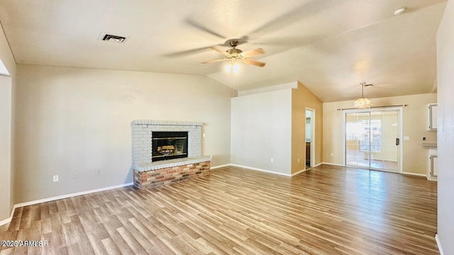 unfurnished living room with a ceiling fan, light wood-style flooring, lofted ceiling, baseboards, and a brick fireplace