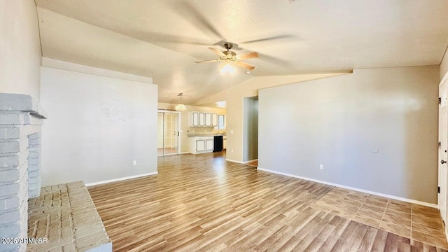 unfurnished living room featuring a ceiling fan, light wood finished floors, vaulted ceiling, and baseboards
