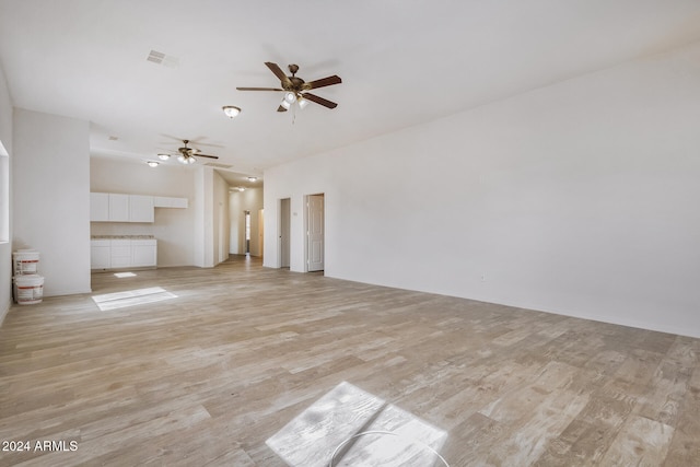 unfurnished living room with light hardwood / wood-style flooring and ceiling fan