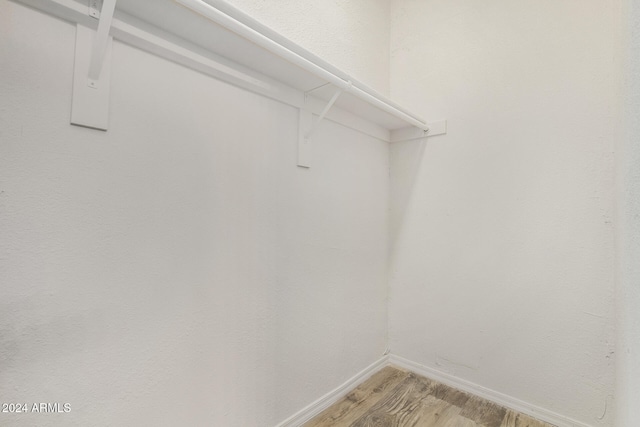 spacious closet featuring hardwood / wood-style flooring