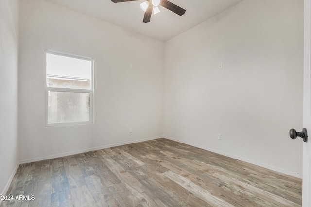 spare room featuring light hardwood / wood-style flooring and ceiling fan