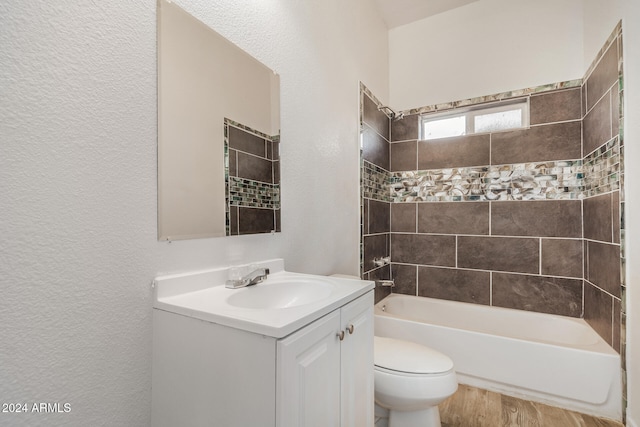 full bathroom featuring vanity, toilet, tiled shower / bath combo, and wood-type flooring