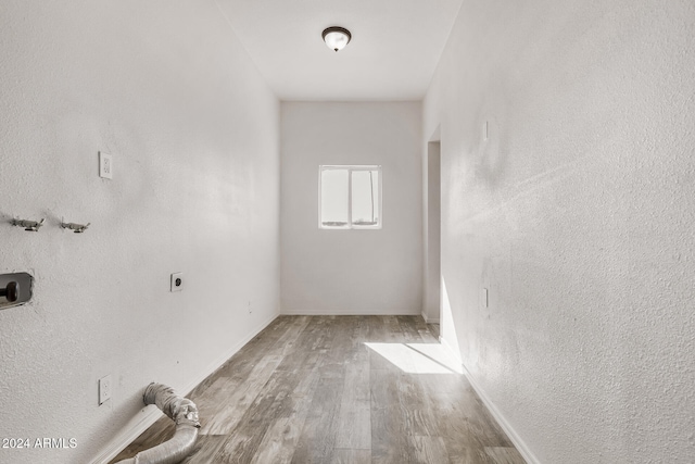 hallway with light hardwood / wood-style floors