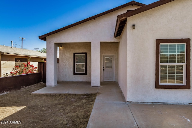 doorway to property with a patio area