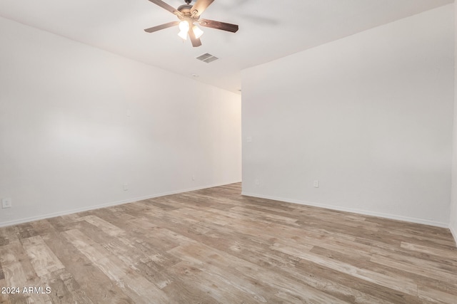 spare room with light hardwood / wood-style flooring and ceiling fan