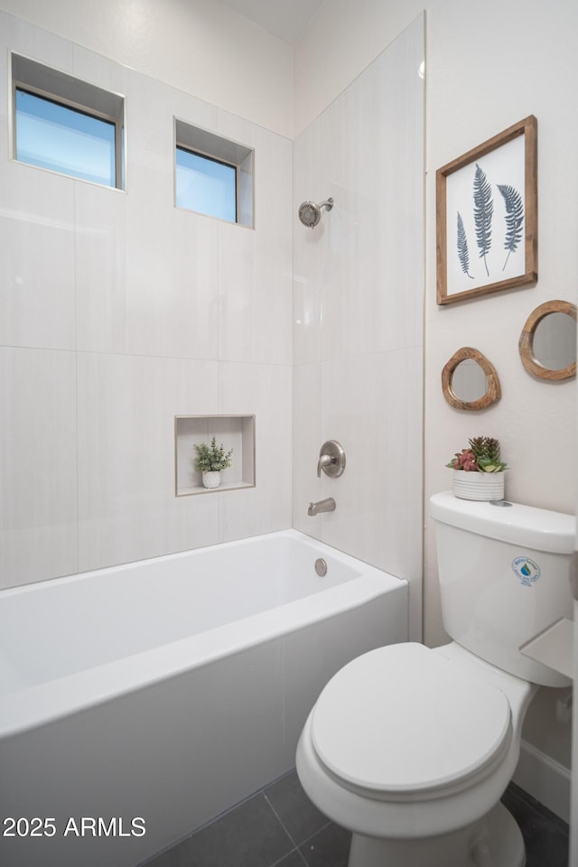 bathroom featuring toilet, tile patterned floors, and bathtub / shower combination