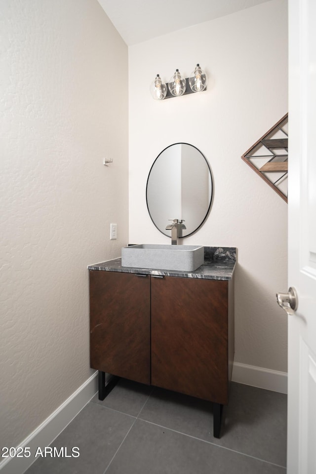 bathroom featuring vanity, baseboards, and tile patterned floors