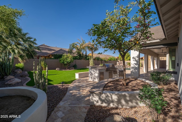 view of patio / terrace featuring an outdoor kitchen and a grill