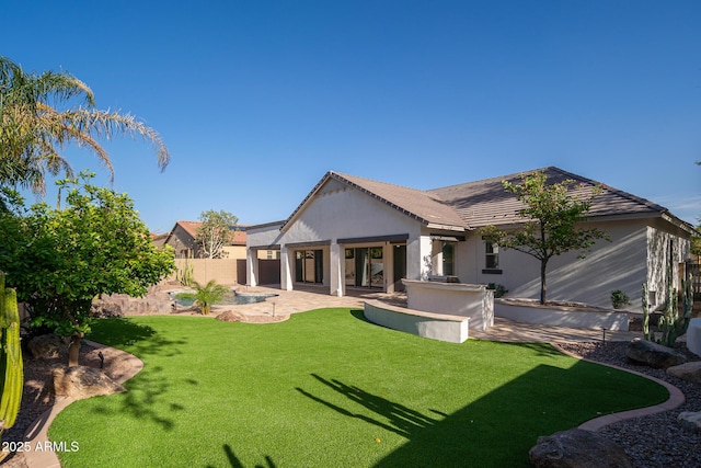 rear view of property with a patio, stucco siding, and a tiled roof