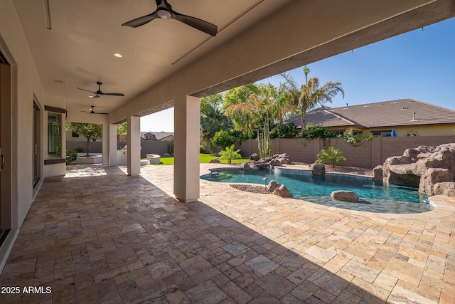 view of swimming pool featuring ceiling fan, a fenced backyard, and a patio area