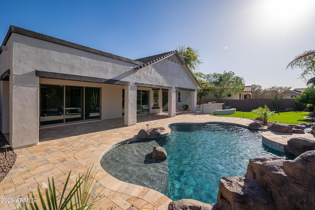 view of pool with a jacuzzi, a patio, and fence