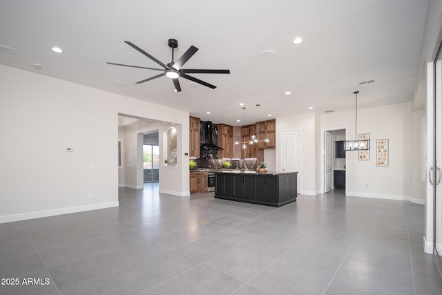 living area with a ceiling fan, recessed lighting, a chandelier, tile patterned flooring, and baseboards