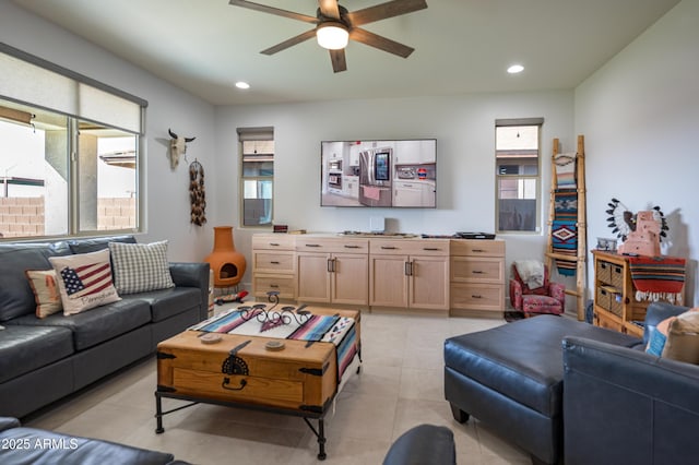 living room featuring plenty of natural light, ceiling fan, and light tile patterned flooring