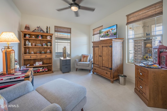 sitting room featuring ceiling fan