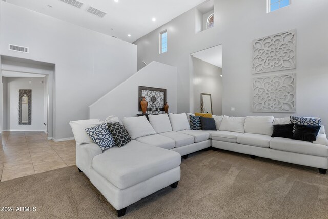 tiled living room with a high ceiling