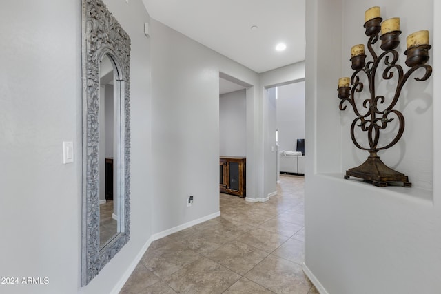 hall with light tile patterned floors