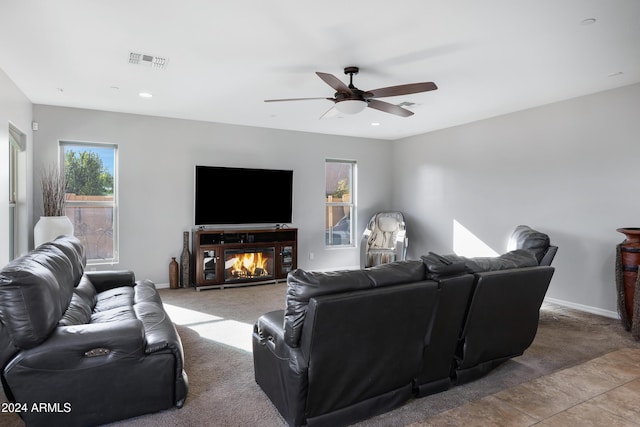 living room with ceiling fan and light tile patterned flooring