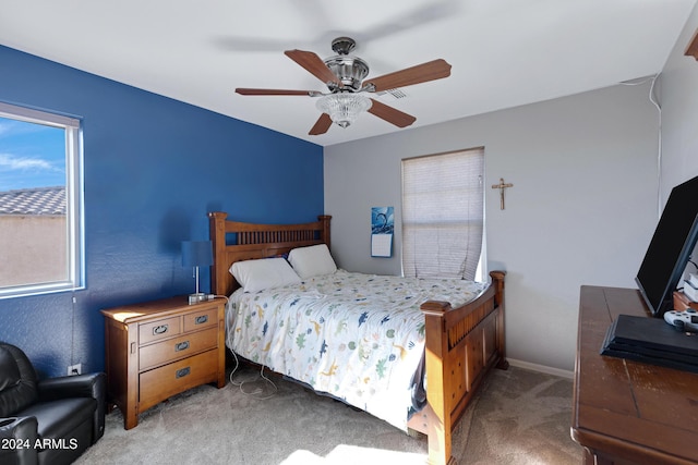 bedroom featuring ceiling fan and carpet