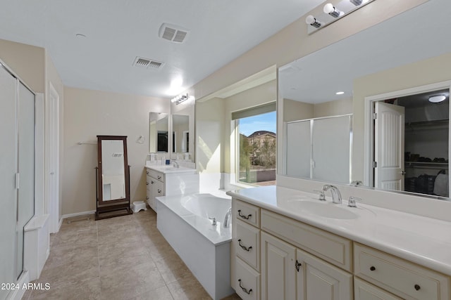 bathroom featuring tile patterned floors, plus walk in shower, and vanity