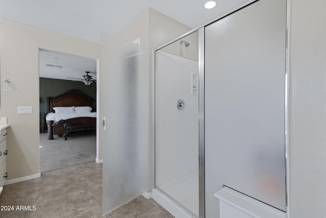 bathroom featuring tile patterned flooring, vanity, ceiling fan, and a shower with shower door