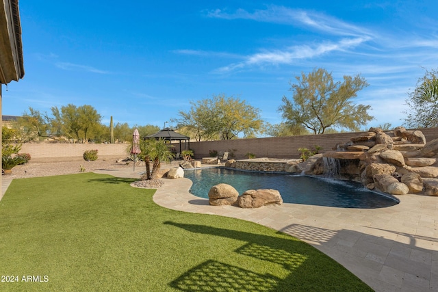 view of swimming pool with a gazebo, pool water feature, and a lawn