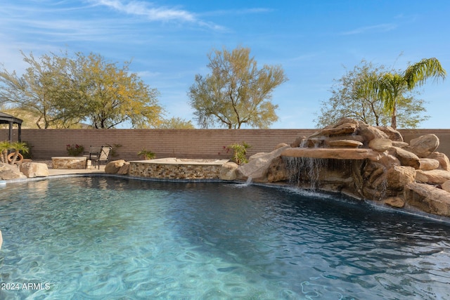 view of swimming pool featuring pool water feature