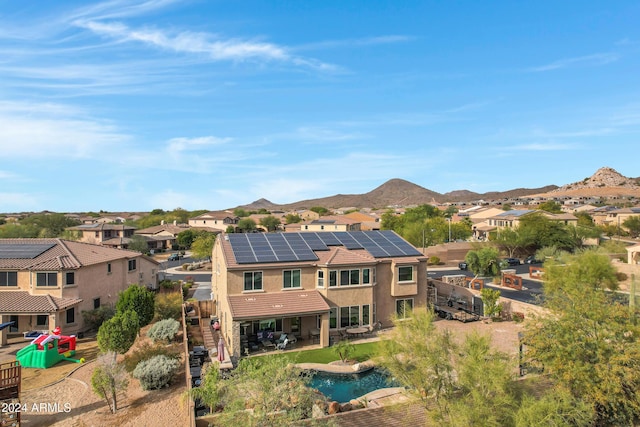 exterior space featuring a mountain view and solar panels