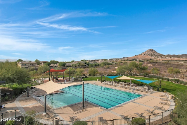 view of swimming pool featuring a patio area and a mountain view