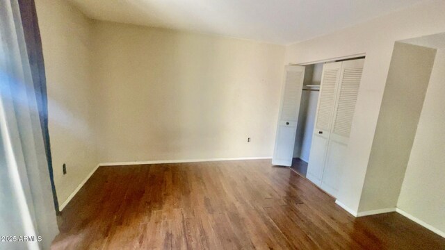3404 W Tangerine Ln, Phoenix, AZ 85051 - unfurnished bedroom featuring wood finished floors, a closet, and baseboards