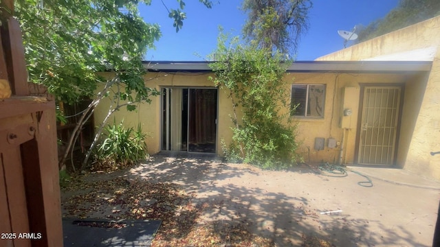 3404 W Tangerine Ln, Phoenix, AZ 85051 - view of exterior entry with stucco siding and a patio