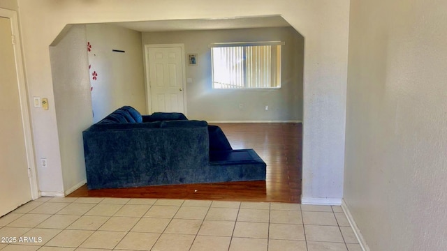 3404 W Tangerine Ln, Phoenix, AZ 85051 - tiled living room with baseboards and arched walkways
