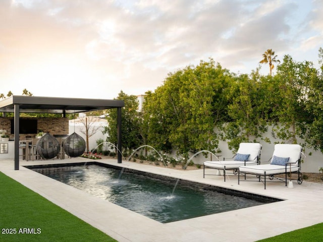 view of pool with fence, a gazebo, a fenced in pool, a bar, and a patio area