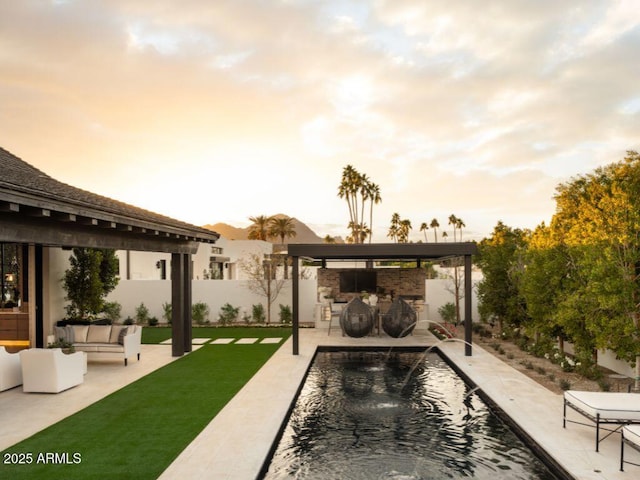 pool featuring fence, an outdoor living space, a bar, and a patio