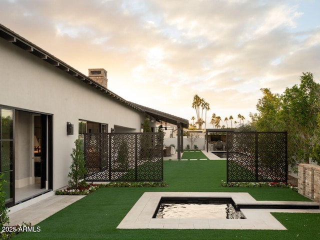 view of yard at dusk