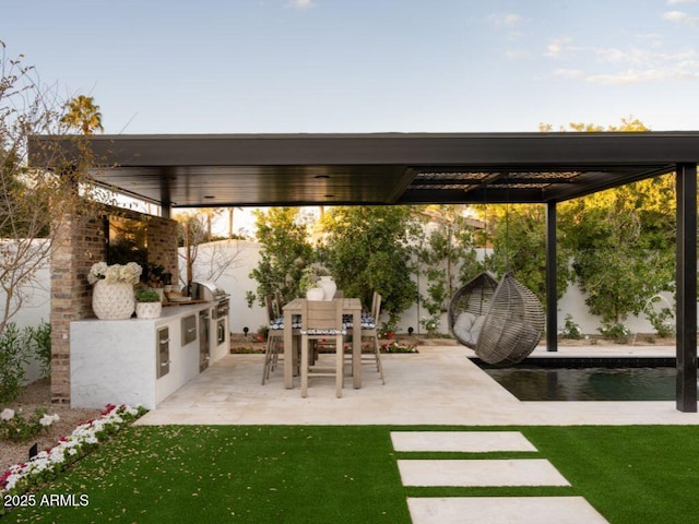 view of patio / terrace featuring exterior kitchen and outdoor dining area