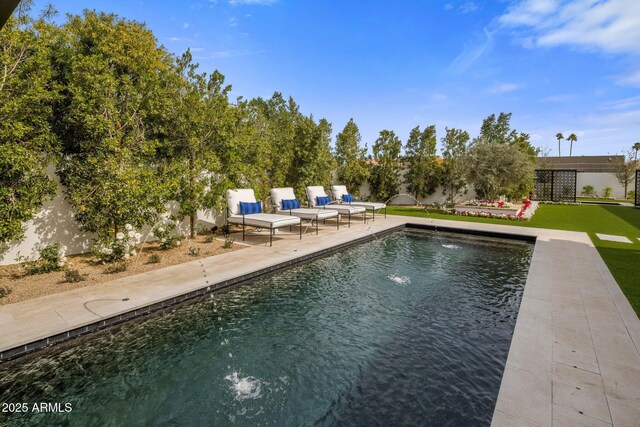 pool featuring a patio area and a yard