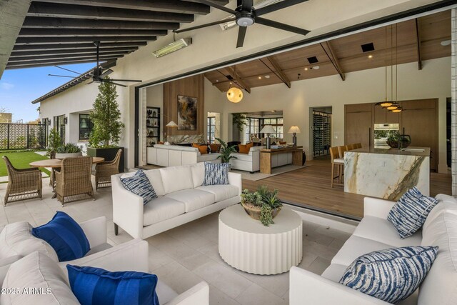 view of patio with a ceiling fan, outdoor dining area, outdoor lounge area, and a wooden deck