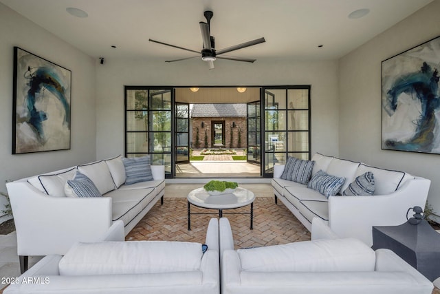 living room with ceiling fan and brick floor