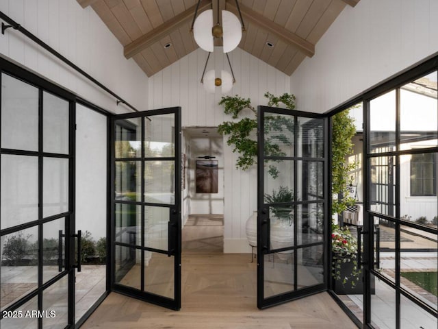 interior space with high vaulted ceiling, french doors, and beam ceiling