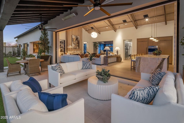 exterior space featuring tile patterned flooring, wood ceiling, a ceiling fan, and beam ceiling