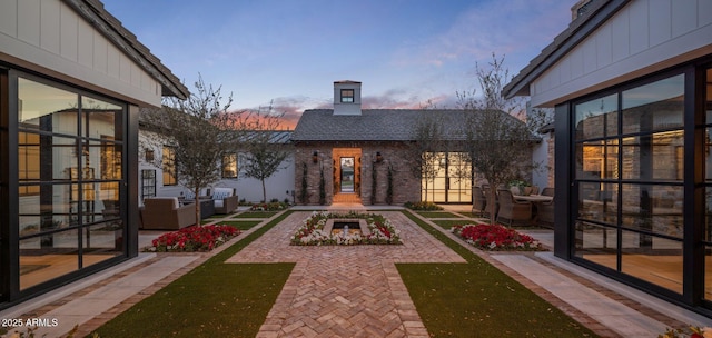 patio terrace at dusk featuring outdoor lounge area