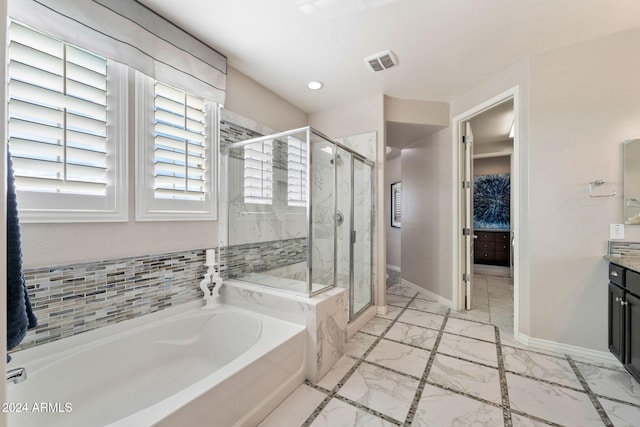 bathroom with vanity and independent shower and bath