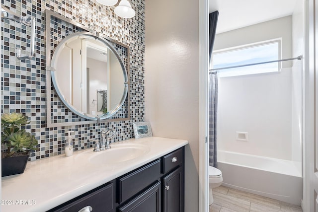 full bathroom with shower / bath combination, toilet, decorative backsplash, vanity, and tile walls