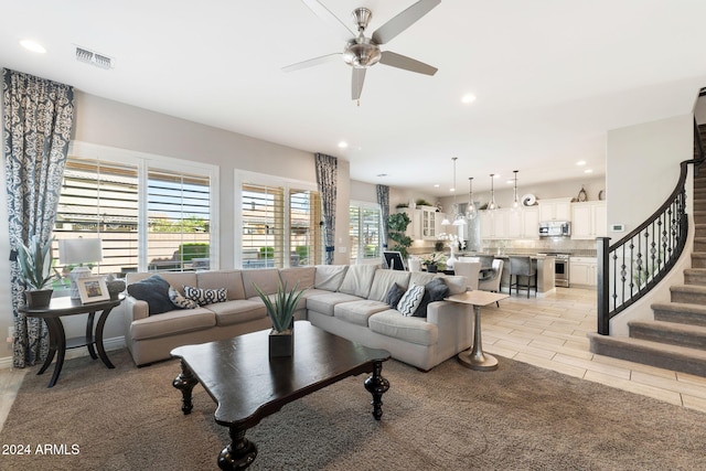 living room with ceiling fan and a wealth of natural light