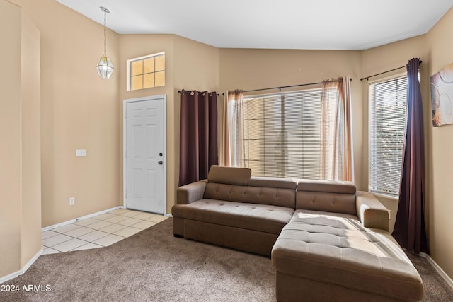 living room featuring light colored carpet and vaulted ceiling