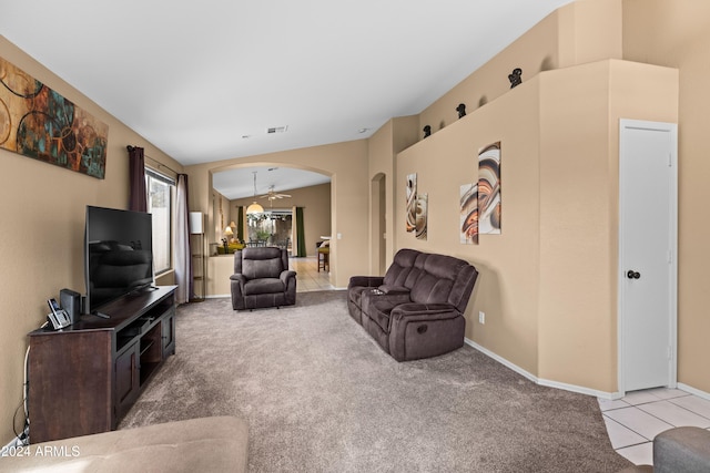 carpeted living room featuring ceiling fan and lofted ceiling