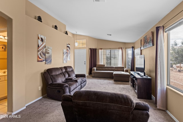 carpeted living room with vaulted ceiling