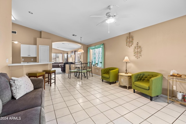 tiled living room featuring ceiling fan and lofted ceiling