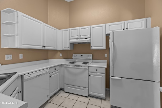 kitchen with white cabinets, white appliances, and light tile patterned floors