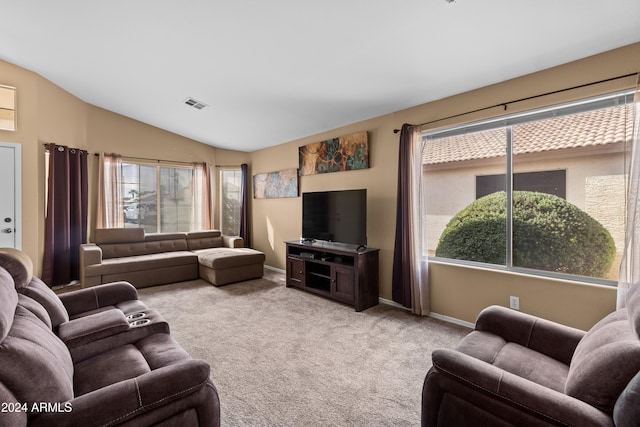 living room featuring light colored carpet and lofted ceiling